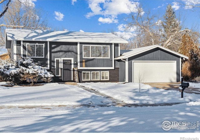 view of front of property featuring a garage and brick siding