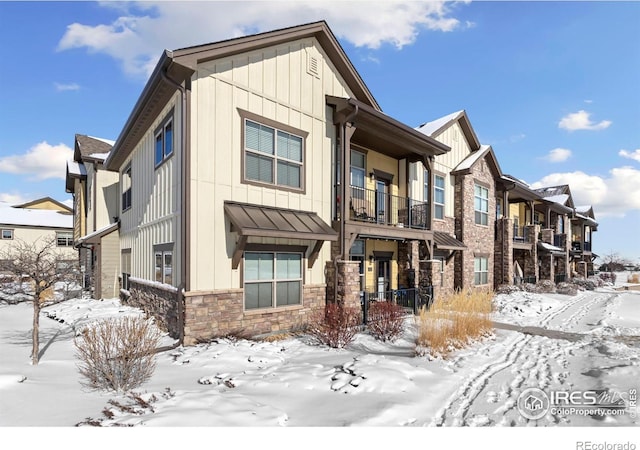 view of snowy exterior featuring a balcony