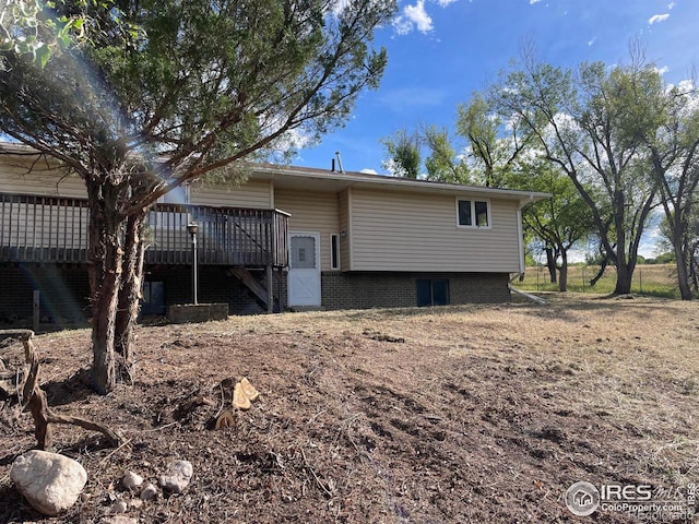 back of property featuring a wooden deck