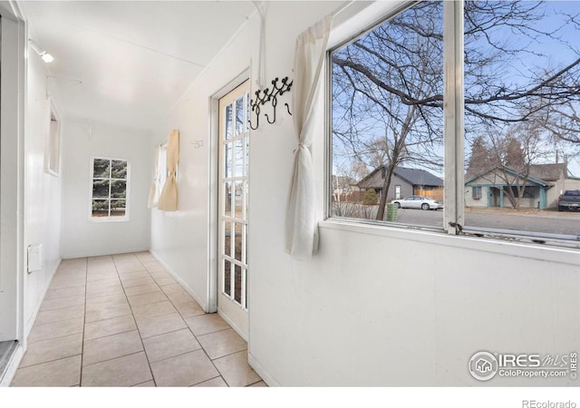 interior space with light tile patterned floors and a wealth of natural light