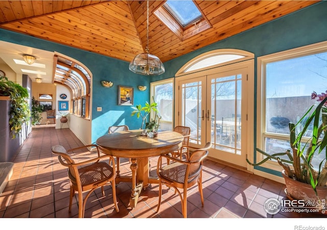 dining area featuring wooden ceiling, lofted ceiling with skylight, french doors, and tile patterned flooring