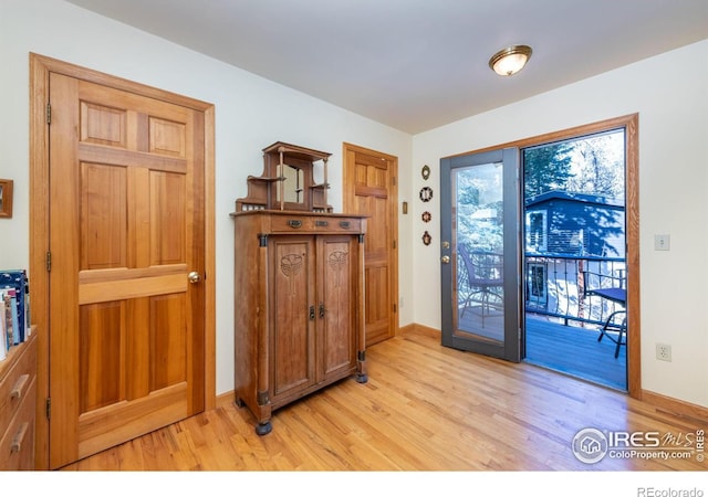 doorway with light wood-type flooring