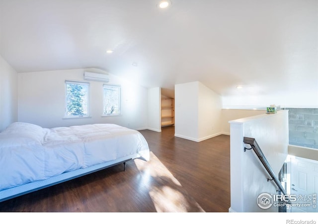 bedroom featuring an AC wall unit, dark hardwood / wood-style floors, and lofted ceiling