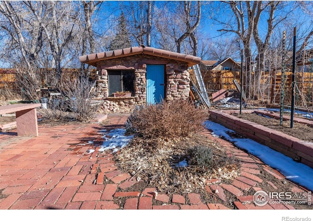 view of front of home with a shed