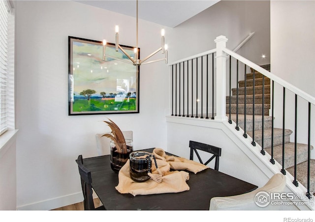 dining area featuring wood-type flooring and an inviting chandelier