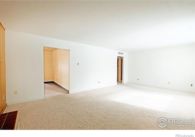 unfurnished room with light carpet