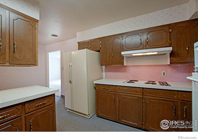 kitchen with white appliances and backsplash