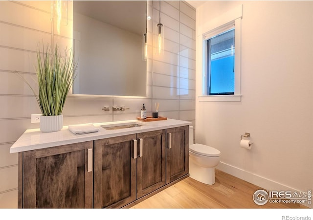 bathroom with vanity, hardwood / wood-style flooring, and toilet