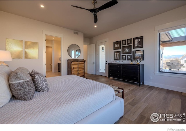 bedroom with dark hardwood / wood-style floors and ceiling fan