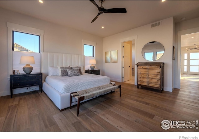 bedroom with ceiling fan and hardwood / wood-style flooring