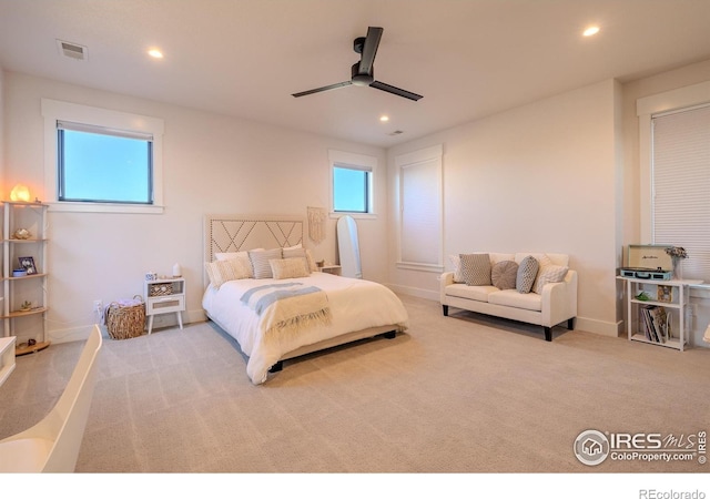 bedroom with ceiling fan and light colored carpet