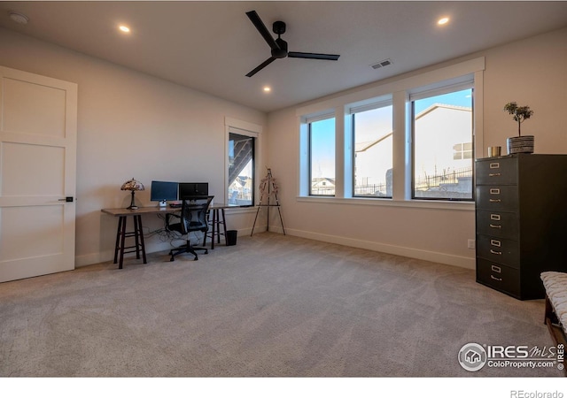 office space featuring ceiling fan and light colored carpet