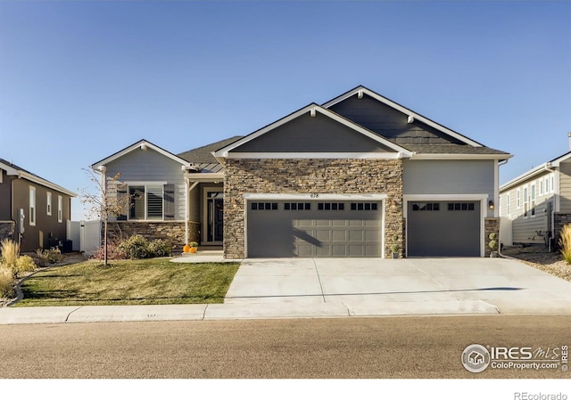 craftsman house with a garage and a front yard