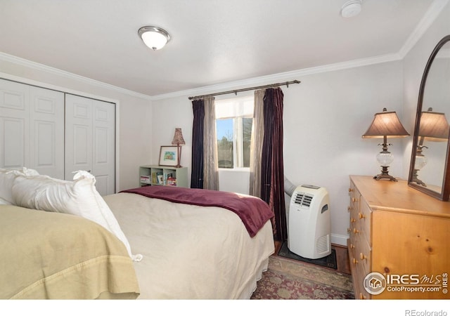 bedroom with crown molding and a closet