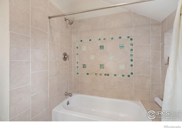 bathroom featuring lofted ceiling