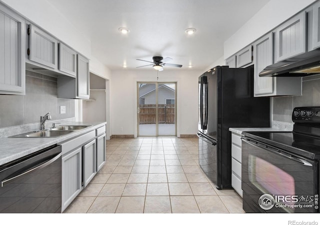 kitchen featuring black appliances, light tile patterned floors, gray cabinetry, and sink