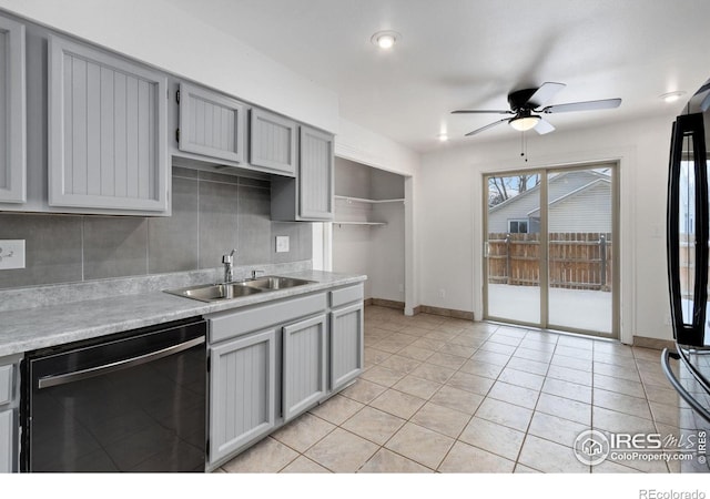 kitchen with sink, black appliances, tasteful backsplash, and gray cabinetry