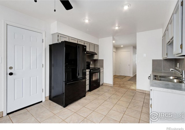 kitchen featuring sink, tasteful backsplash, gray cabinetry, light tile patterned floors, and black appliances