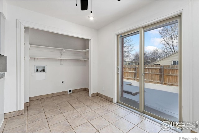 laundry room featuring ceiling fan, washer hookup, light tile patterned floors, and hookup for an electric dryer