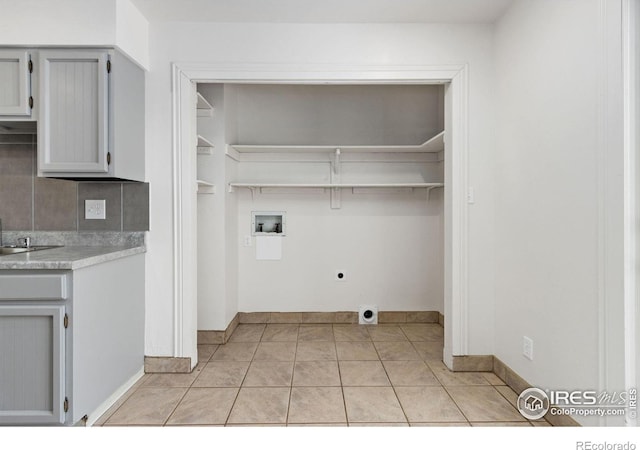 laundry room featuring light tile patterned floors, hookup for a washing machine, and hookup for an electric dryer