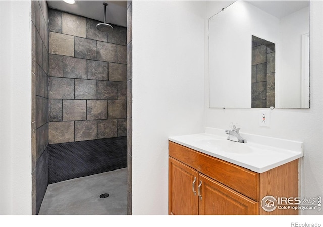 bathroom featuring vanity and a tile shower