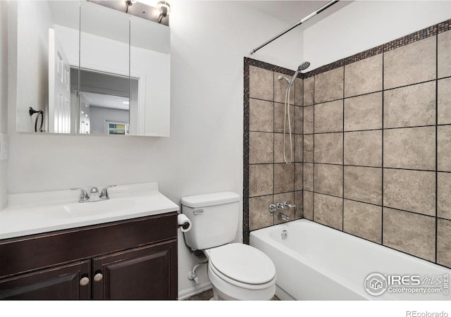 full bathroom with tiled shower / bath combo, toilet, and vanity