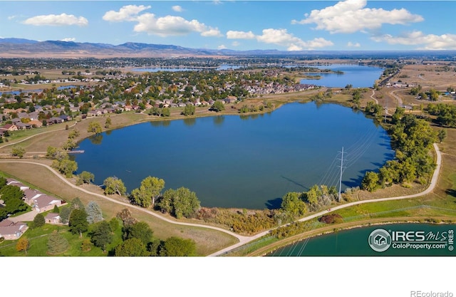 drone / aerial view featuring a water and mountain view