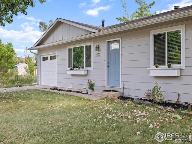 view of front of property with a garage and a front yard