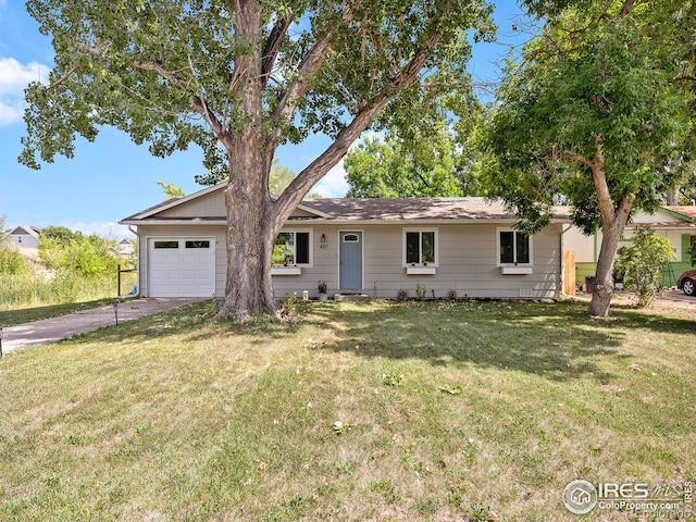 ranch-style home featuring a garage and a front lawn