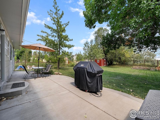 view of patio featuring grilling area and a shed