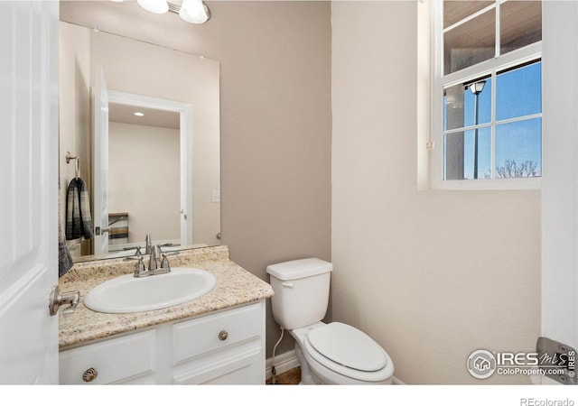 bathroom with toilet and vanity