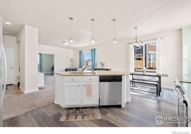 kitchen featuring light stone countertops, pendant lighting, white cabinets, appliances with stainless steel finishes, and sink