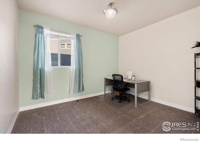 unfurnished office with dark colored carpet