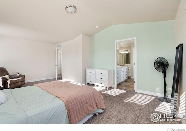 carpeted bedroom with lofted ceiling and ensuite bathroom