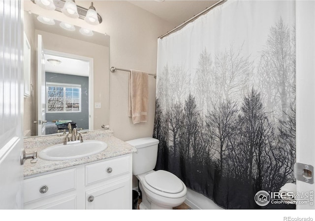 bathroom featuring toilet and vanity