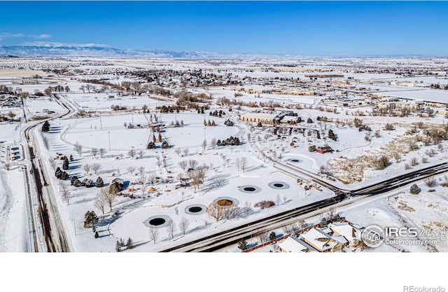 snowy aerial view featuring a mountain view