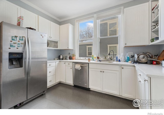 kitchen with white cabinets, tile patterned flooring, stainless steel appliances, sink, and crown molding