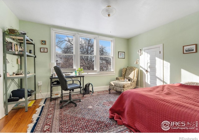 bedroom with hardwood / wood-style flooring