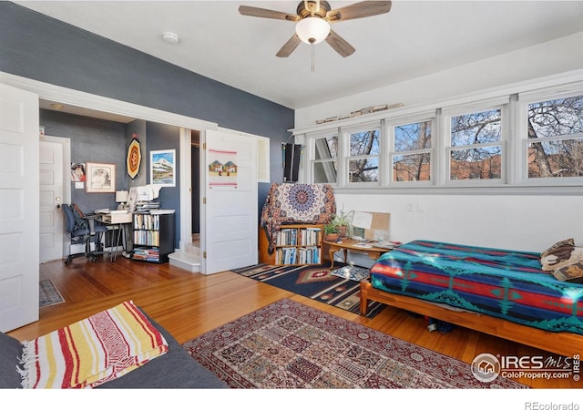 bedroom with ceiling fan and hardwood / wood-style flooring