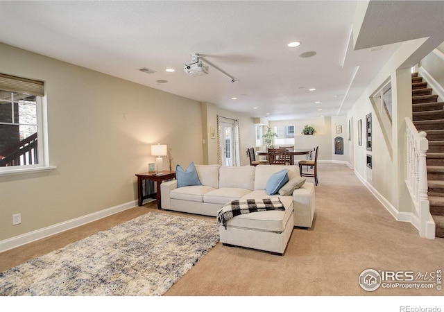 living room featuring a healthy amount of sunlight and light colored carpet