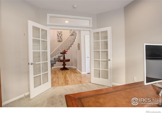 interior space featuring light colored carpet and french doors