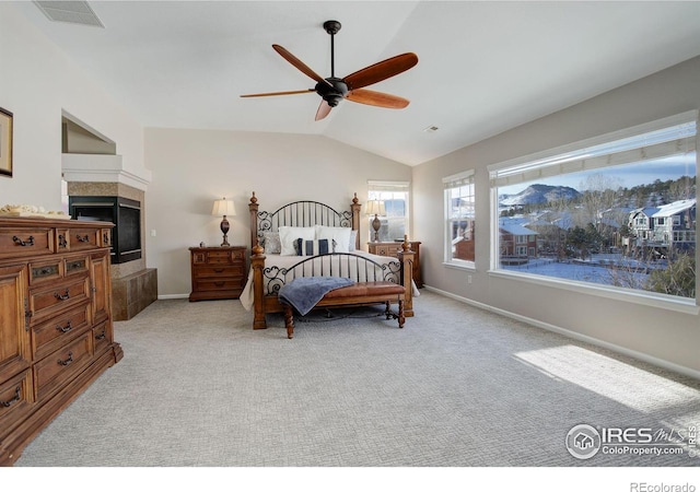 carpeted bedroom featuring ceiling fan and vaulted ceiling