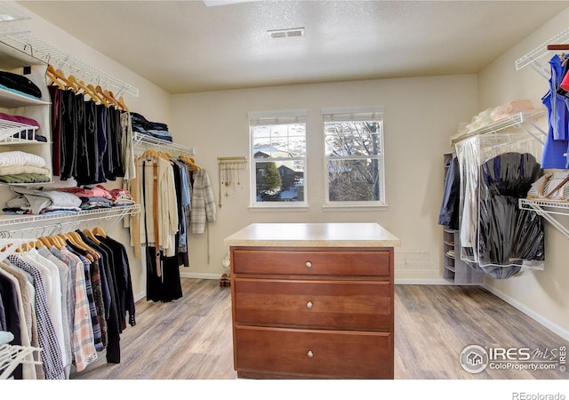 walk in closet featuring light hardwood / wood-style flooring