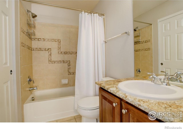 full bathroom with toilet, shower / tub combo with curtain, tile patterned floors, and vanity