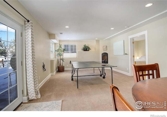 recreation room with light colored carpet and a wealth of natural light