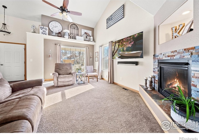 carpeted living room featuring ceiling fan, high vaulted ceiling, and a fireplace