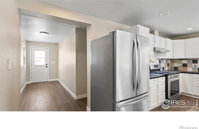 kitchen with backsplash, white cabinetry, dark hardwood / wood-style floors, and stainless steel appliances