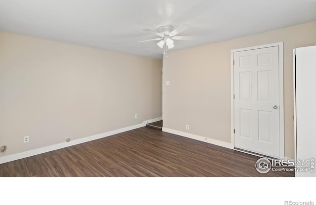 empty room featuring ceiling fan and dark wood-type flooring