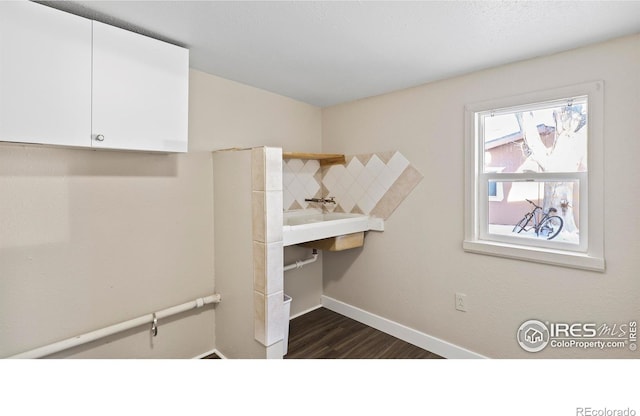 laundry room with dark wood-type flooring