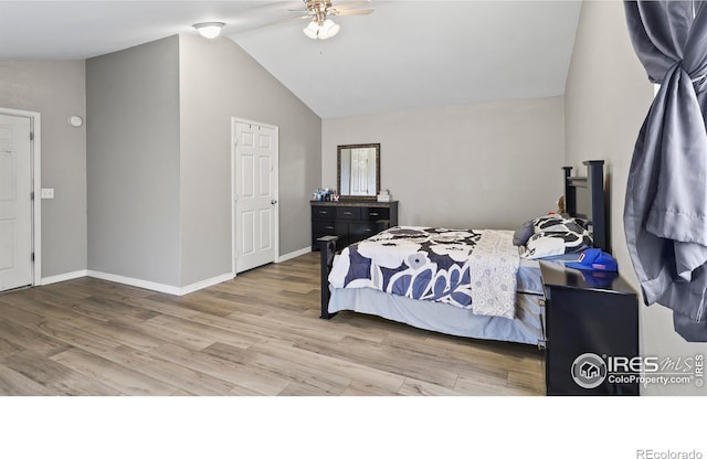 bedroom with lofted ceiling, hardwood / wood-style floors, and ceiling fan